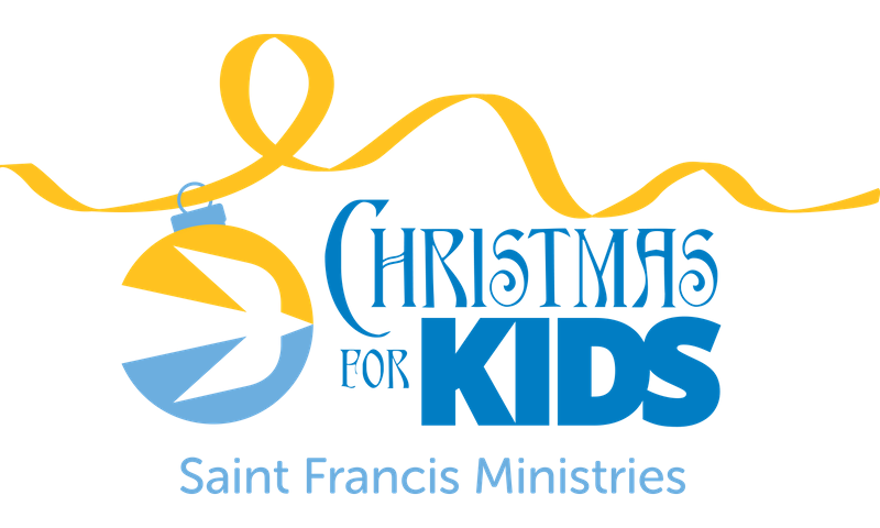 A logo featuring a yellow and blue Christmas ornament illustration with a yellow ribbon looped above it. To the right, blue text reads "Christmas for Kids." Below, it says "Saint Francis Ministries" in a smaller blue font.