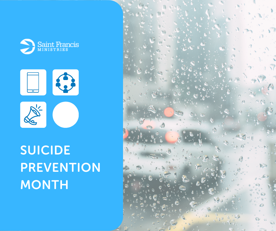 A rainy city street with blurred tail lights is visible through a window. On the left, a blue overlay features four icons: a phone, a network, a megaphone, and a white circle. Text reads "Saint Francis Ministries" and "Suicide Prevention Month.