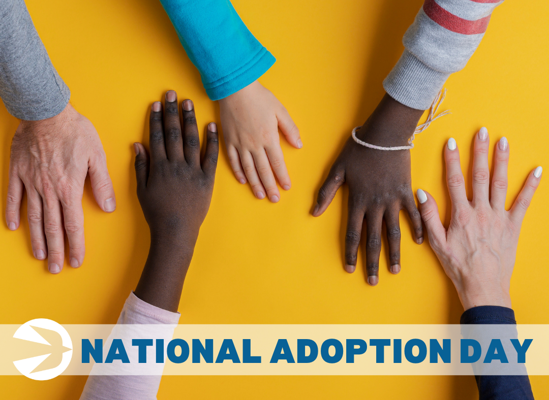 Six hands of various sizes and skin tones placed on a yellow background. The image features an arrow and the text "National Adoption Day" at the bottom.