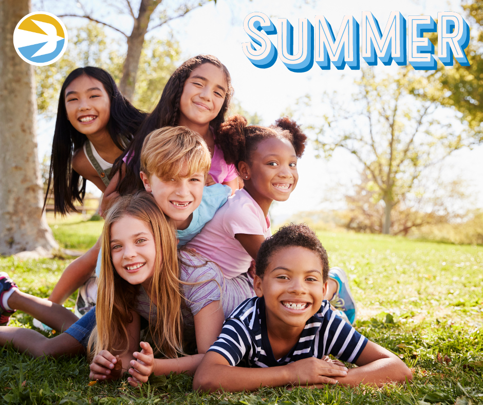 Six children smile and pose in a playful stacked pyramid formation outdoors. Trees and greenery are visible in the background under a bright sky. The word "SUMMER" is displayed in large, stylized letters in the top right corner.