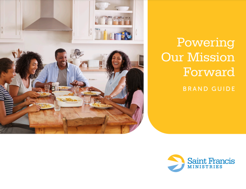 A family of five is sitting around a wooden dining table, sharing a meal and smiling. The text on the right side of the image reads "Powering Our Mission Forward," and below it, "Brand Guide" with the Saint Francis Ministries logo.