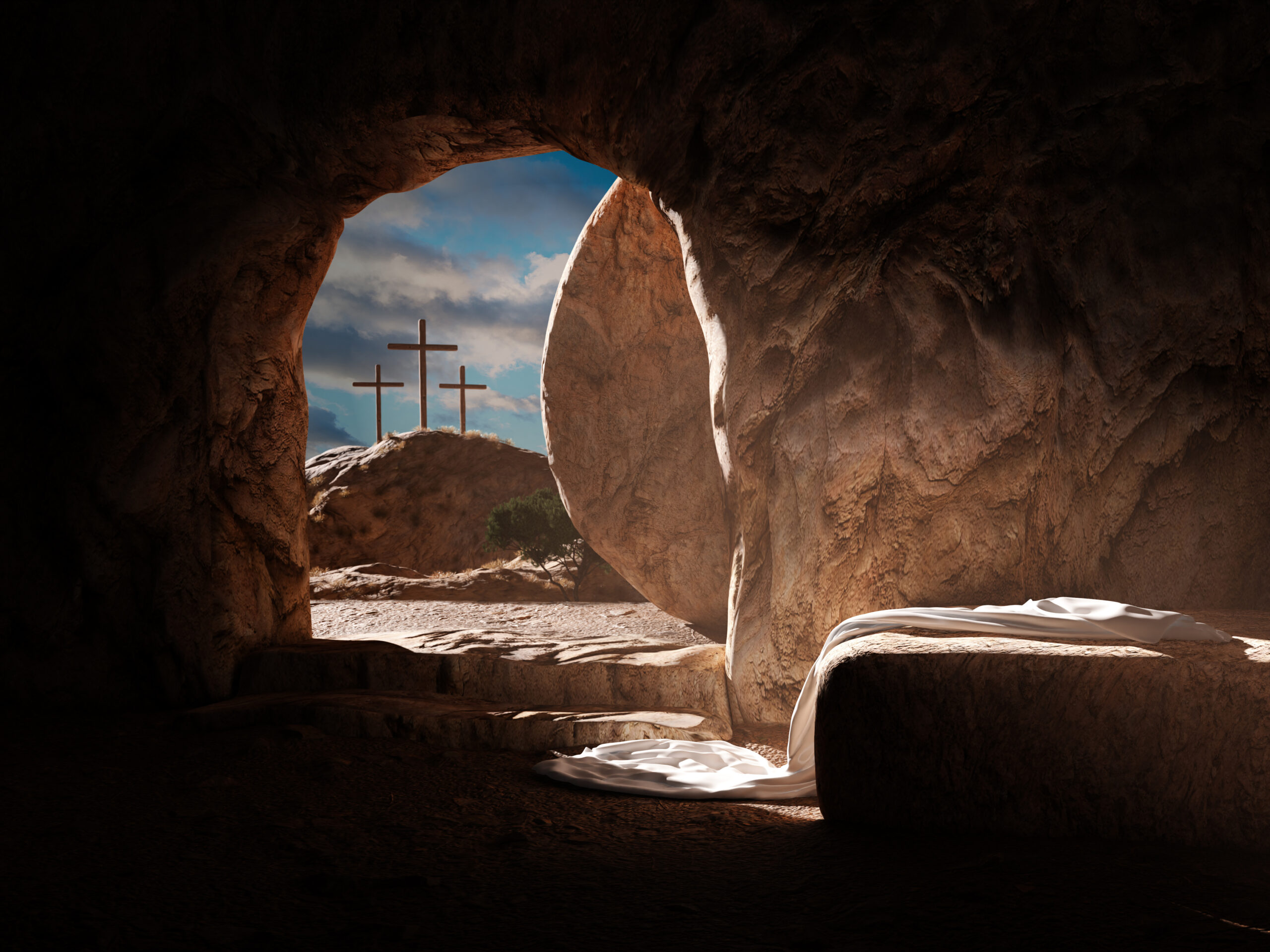 A stone cave with a rounded entrance shows a large rock moved aside. Sunlight illuminates an empty stone slab draped with a white cloth. Three wooden crosses are visible on a hill outside the cave against a cloudy sky.