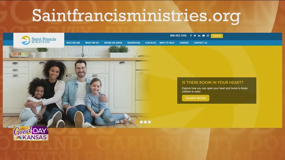 A family of four sits on the floor in a kitchen, smiling. The overlaying text reads "Saintfrancisministries.org" along with website navigation links and a headline "Is there room in your heart?" promoting fostering children. The backdrop includes "Good Day Kansas.