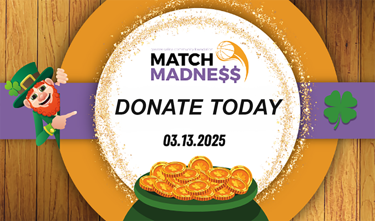 A leprechaun and shamrock frame a circular banner with the text "Match Madness" and "Donate Today" above a pot of gold coins. The date "03.13.2025" is written in the center. The background features wooden textures.